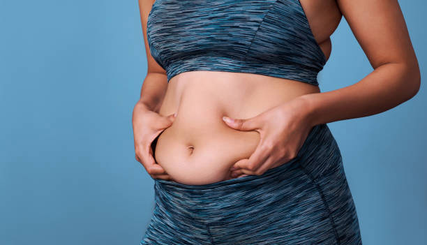 Person holding abdomen, showing weight regain concerns