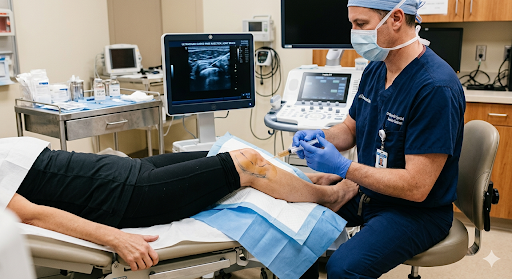 Doctor giving an ultrasound-guided stem cell injection into a patient's knee joint.